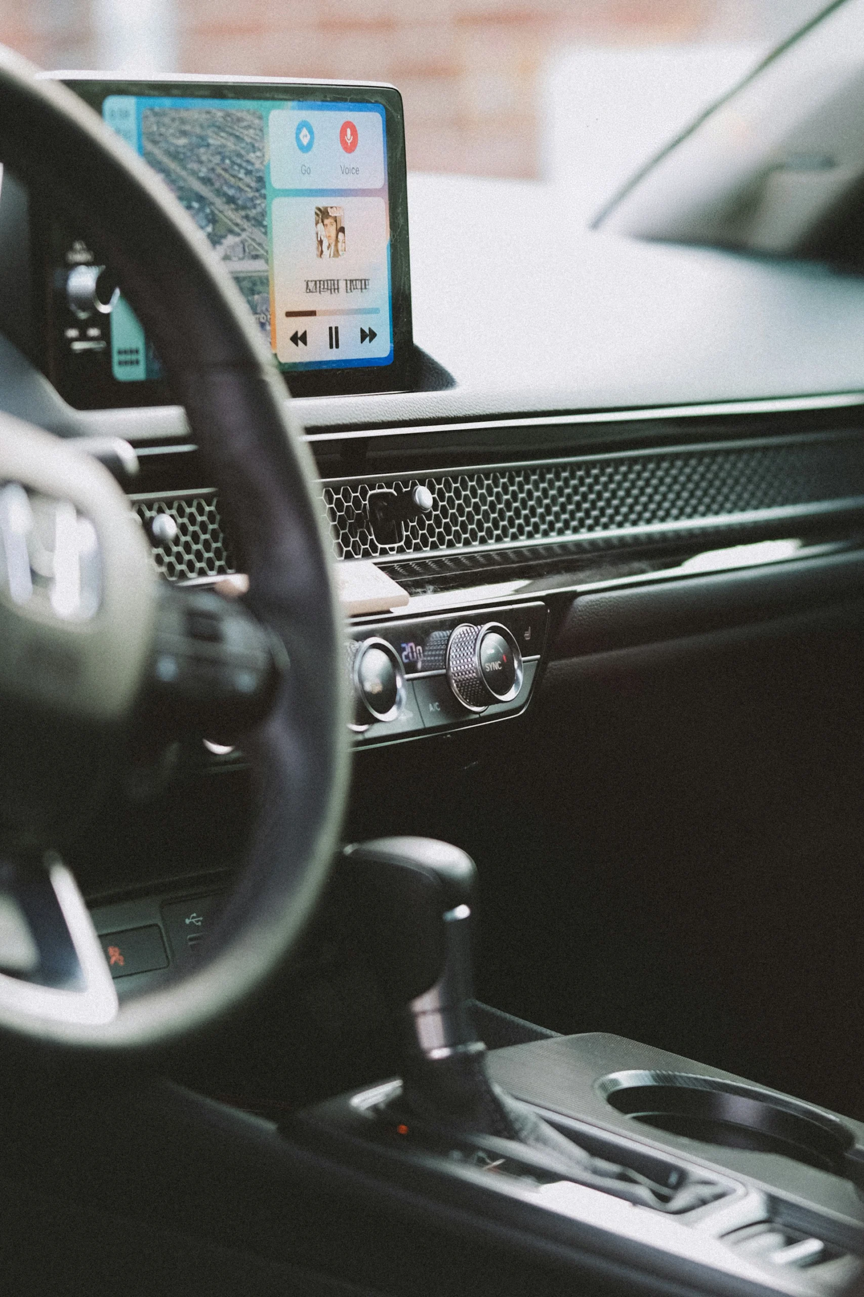 Honda Certified Collision Repair Systems Honda vehicle interior with steering wheel, infotainment screen, and climate controls.
