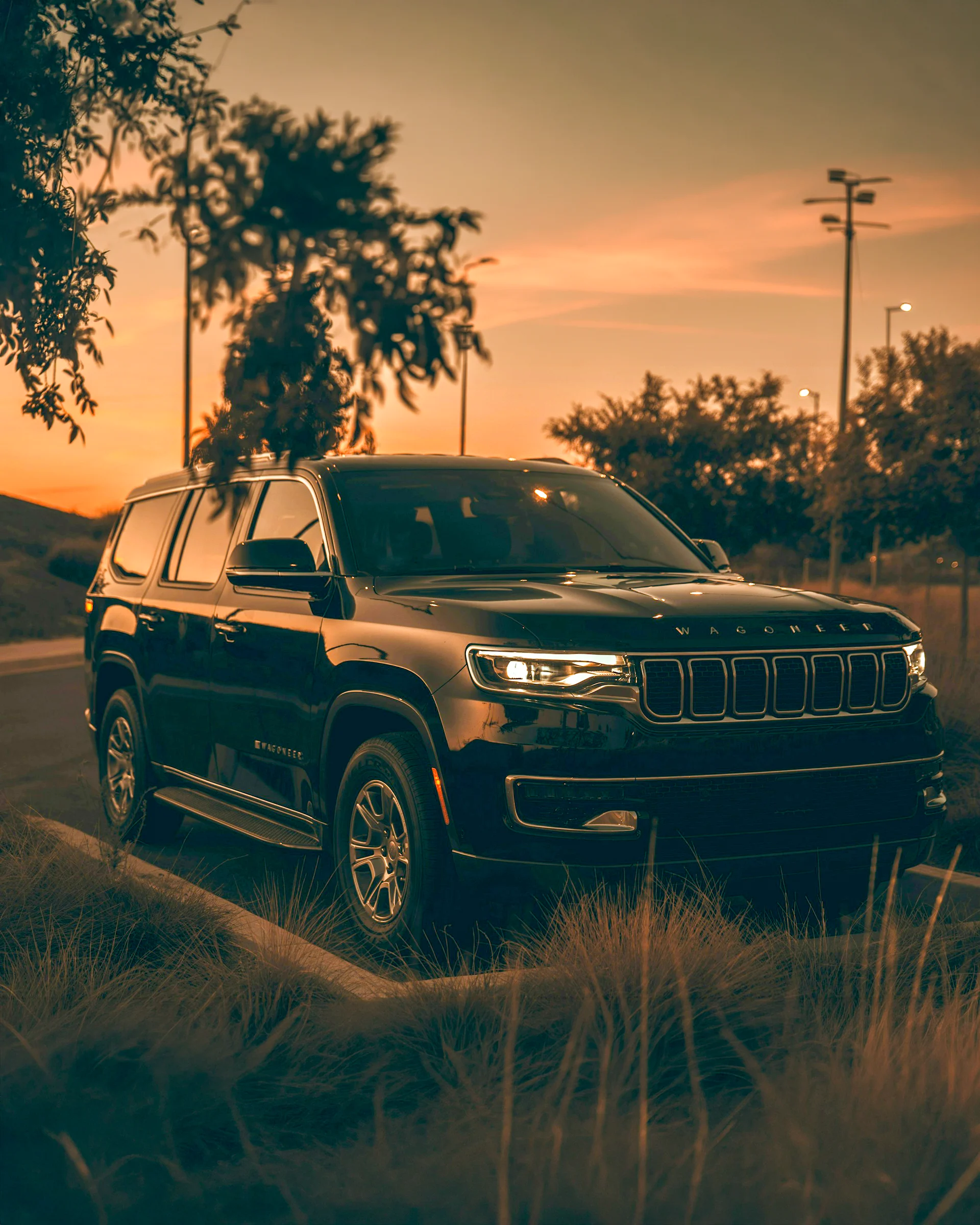 Jeep Wagoneer SUV parked outdoors at sunset.
